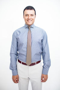 Portrait of smiling man standing against white background