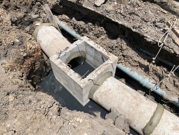 High angle view of old abandoned construction site. concrete sewer in street side.