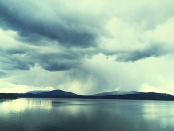 Scenic view of lake against cloudy sky