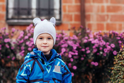 Portrait of a happy smiling child near the house. home leisure, comfort, home buying