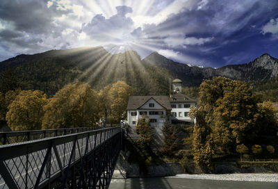 Scenic view of buildings and mountains against sky