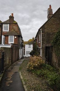 Street amidst buildings against sky