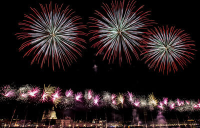 Low angle view of firework display at night