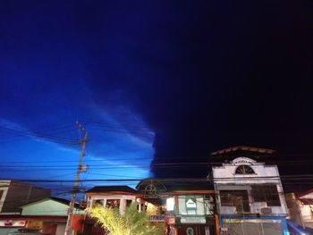 Low angle view of illuminated building against sky at night