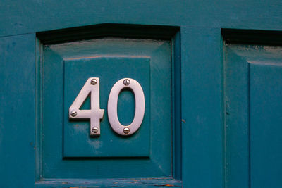 Close-up of text on blue door