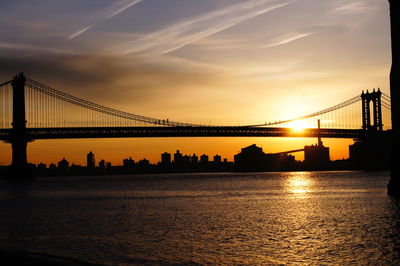 Silhouette of suspension bridge at sunset