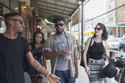 A group of friends walking down a street. 