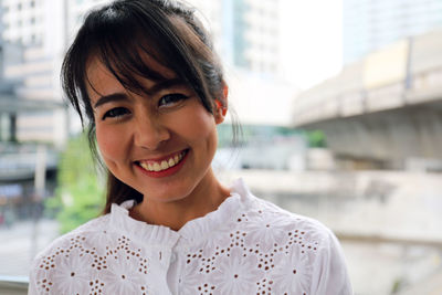 Portrait of smiling woman in city