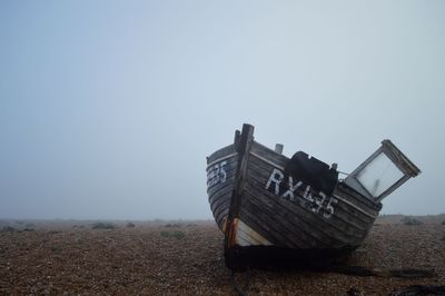 Lifeguard hut on field against clear sky