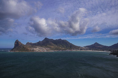Scenic view of sea and mountains against sky