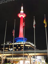 Illuminated buildings against sky at night