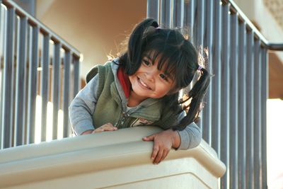 Smiling girl by railing