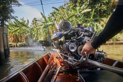 Powerful engine of traditional long tail boat in thailand. hand of drive control boat.
