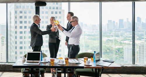 Man and woman standing on table at cafe
