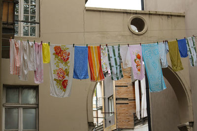 Low angle view of clothes drying against building