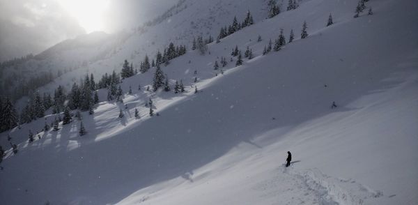 People skiing on snow covered mountain