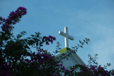 Low angle view of cross against sky