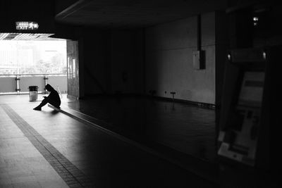 Rear view of silhouette man walking in building