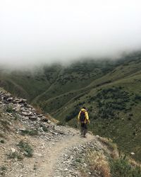 Rear view of person walking in the mountatins