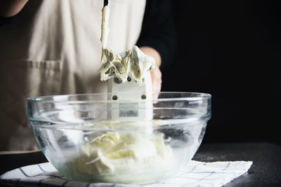 Midsection of ice cream in glass bowl on table