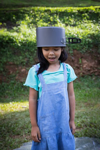 girl wearing cooking utensil standing outdoors