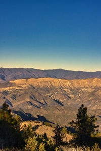 Scenic view of dramatic landscape against clear blue sky