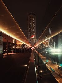 Illuminated city against sky at night