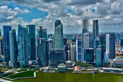 Aerial view of buildings in city against sky