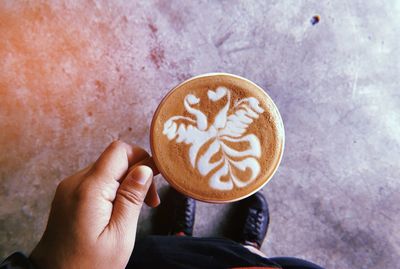 Human hand holding coffee cup