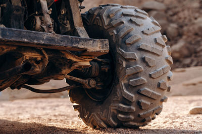 Close-up of rusty wheel on field