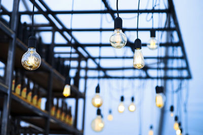 Low angle view of illuminated light bulbs