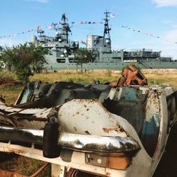 Abandoned truck on field against sky