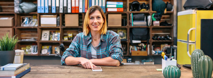 Portrait of young woman sitting in library