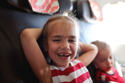 Smiling girl sitting in plane