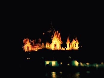 Illuminated building against sky at night