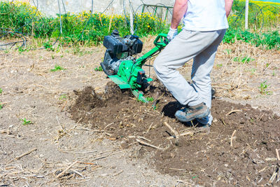 Low section of man working on field