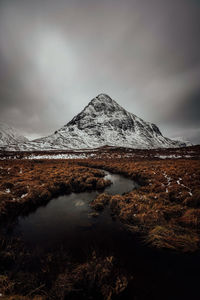 Mountains in rannoch moor in scotland scenic viev with lake and dark cloudy mood sky