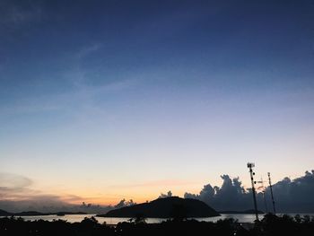 Scenic view of silhouette mountains against sky at sunset