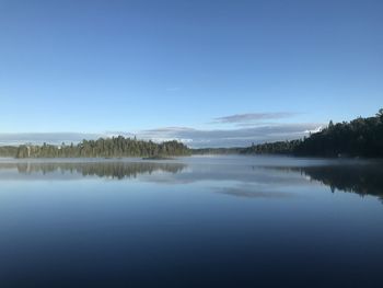 Scenic view of lake against clear blue sky