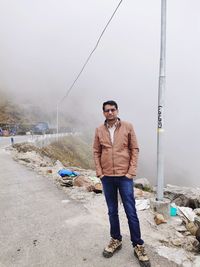 Full length portrait of young man standing outdoors