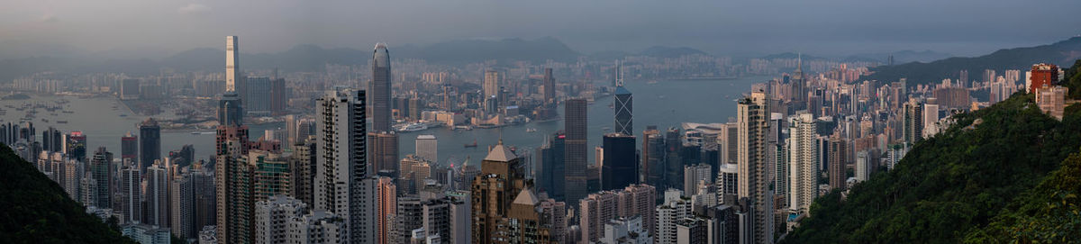 Panoramic view of modern buildings in city against sky