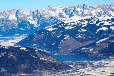 Blue sunny summits of winter frozen alps near zell am see lake in austria