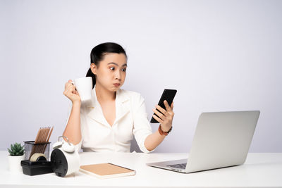 Young woman using laptop on table