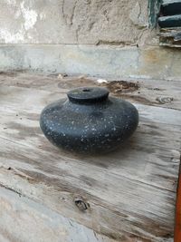 High angle view of stone on wet table against wall