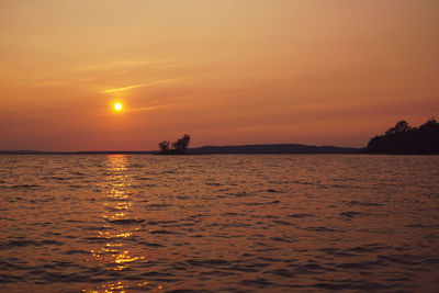 Scenic view of sea against orange sky