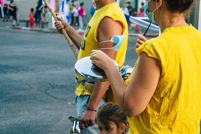 Rear view of people walking on street