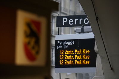 Close-up of information sign on wall