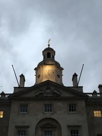 Low angle view of building against cloudy sky