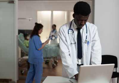 Doctor using digital tablet at clinic