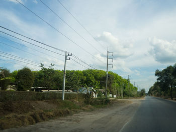 Road amidst trees against sky
